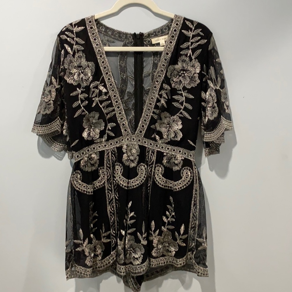 Stunning black ROMPER with plunge neckline perfect for the holidays!!